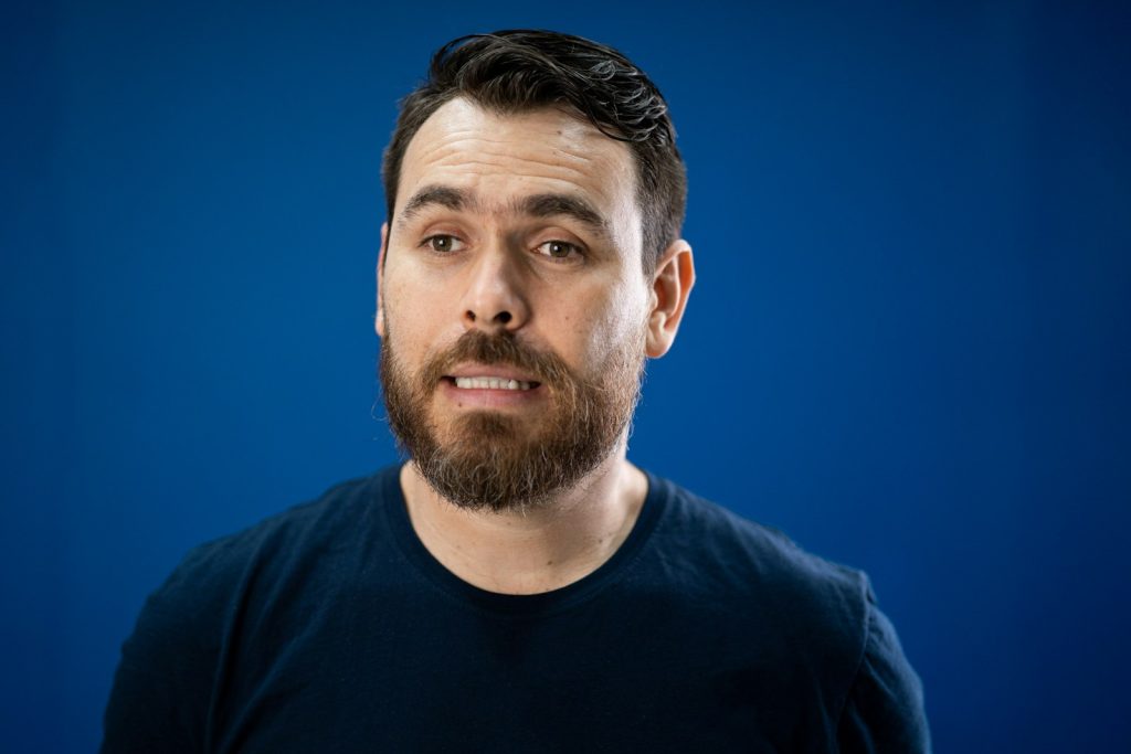 A man with a beard and a black shirt